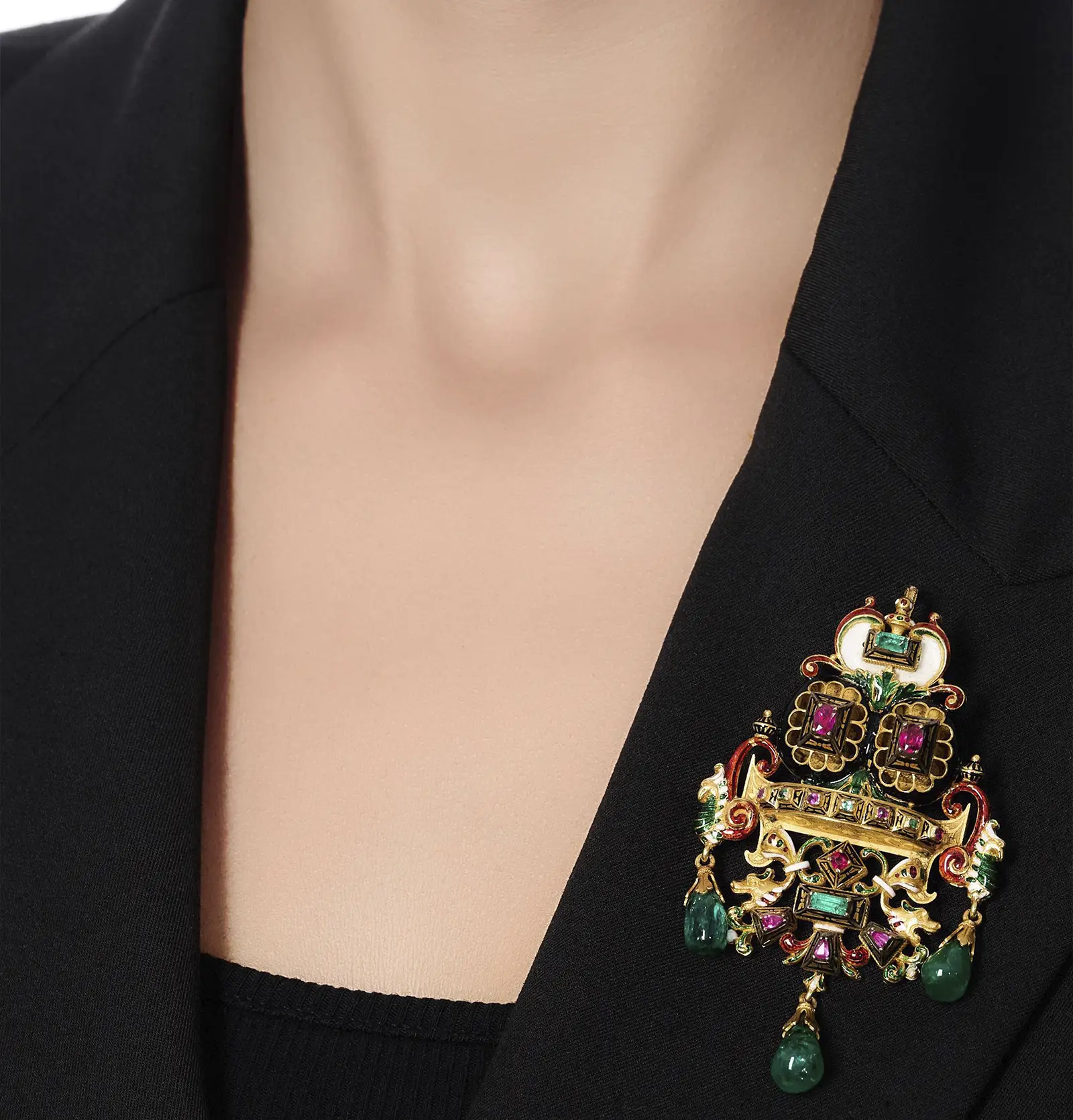 Castellani Emerald ruby and enamel brooch pinned to a black jacket. Sotheby’s Geneva to Present Rare Vintage Jewels on November 13. US