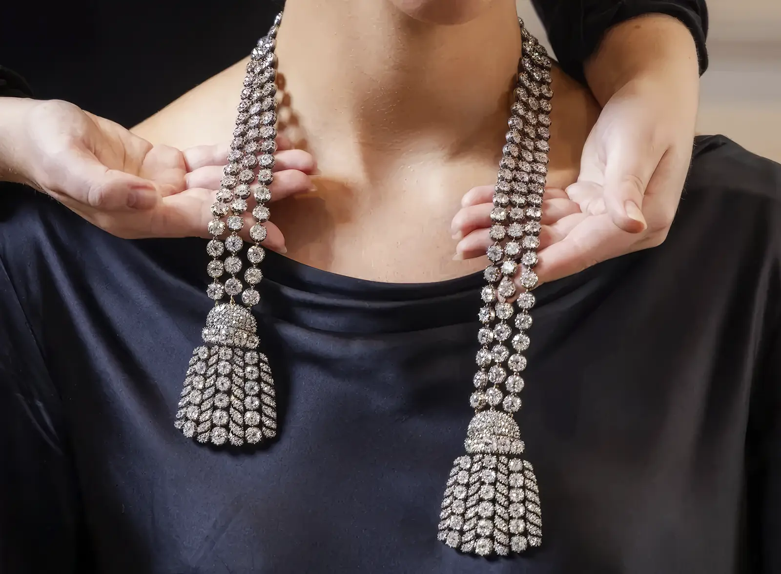 Woman is trying on a diamond necklace. .81 Million for Marie Antoinette’s Necklace or Why Historic Jewels Dominate Modern Auctions. US
