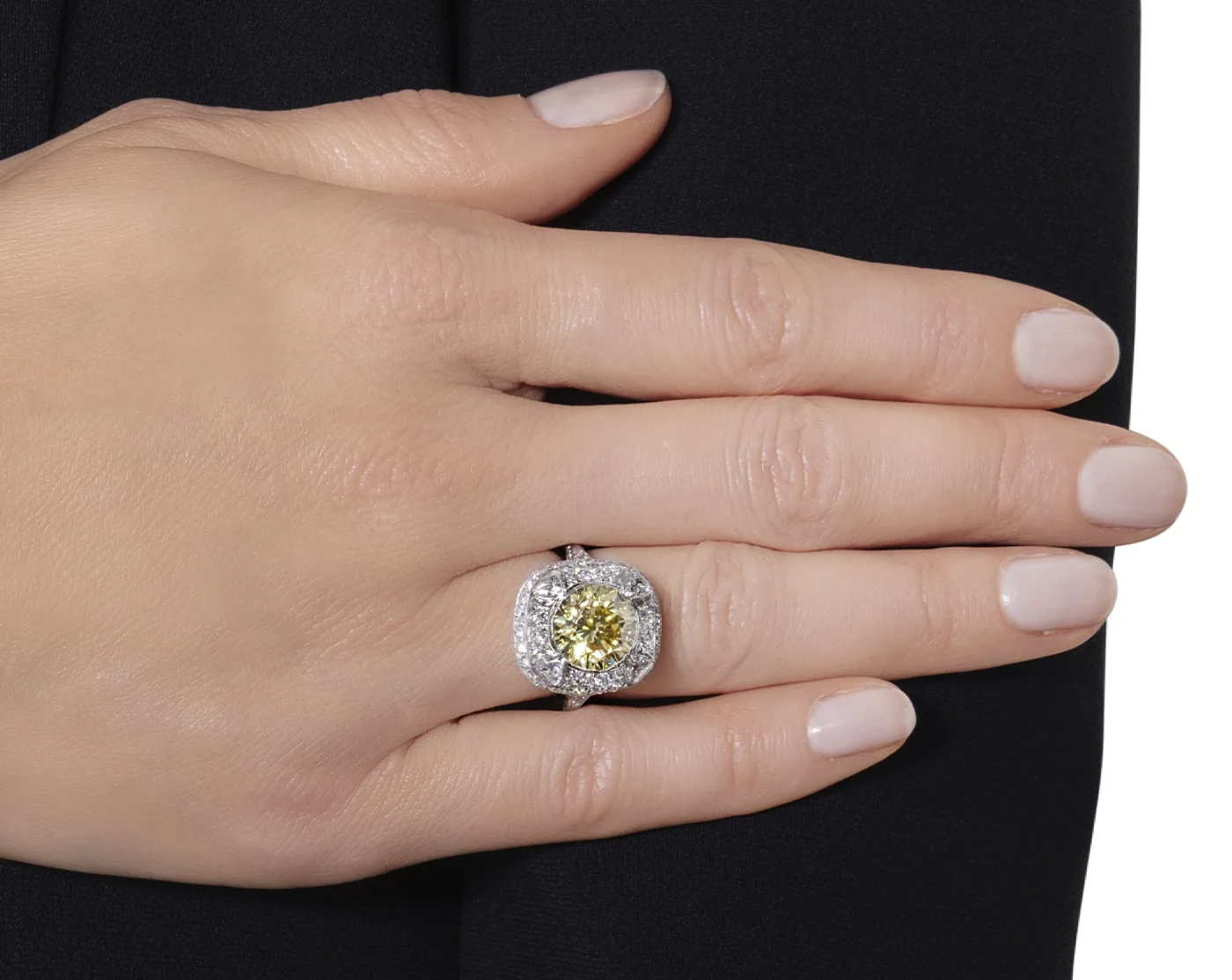 White gold 4.21ct ring that features a fancy vivid yellow VVS1 clarity main diamond on the finger. Sotheby’s Winter Auction Shines with Iconic Jewelry and Charitable Contributions. US