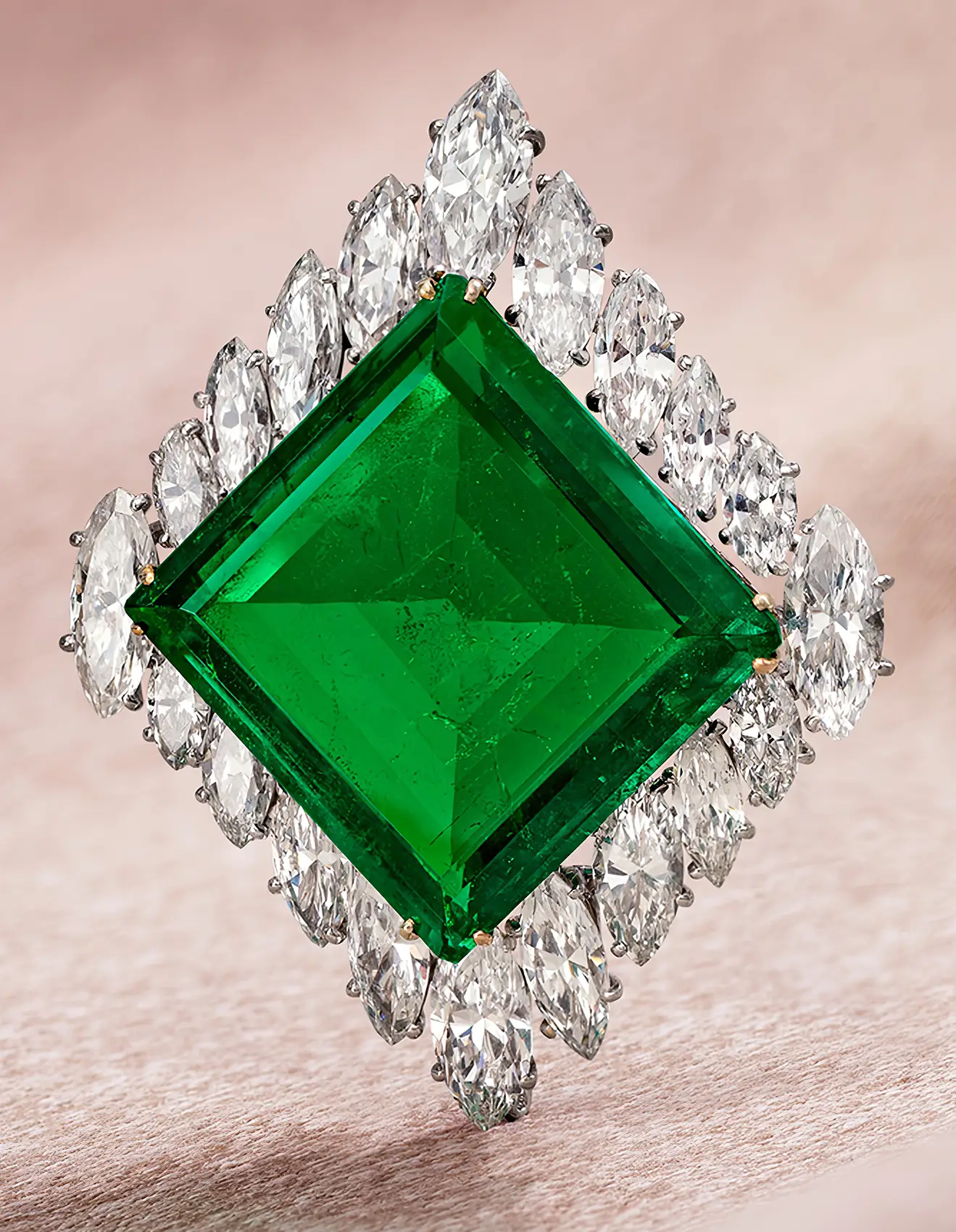 White gold brooch with Colombian emerald 37 carat and clearless marquise diamond, perspective view. From Love to Legacy: The Story Behind the World’s Most Expensive Emerald. US