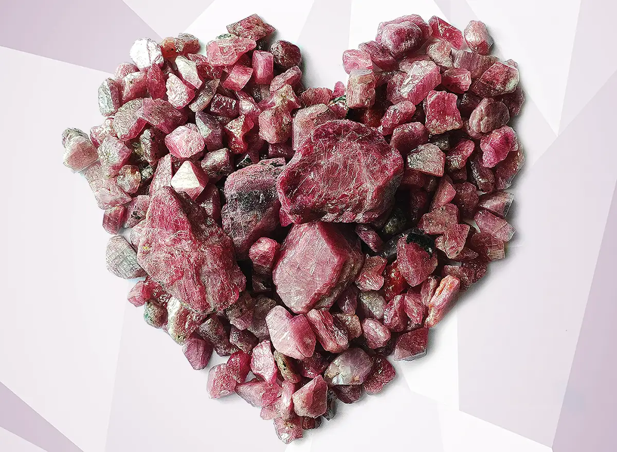 Rough rubies crystals laid out in a heart shape. A Mixed-quality Rough Ruby Auction Brings Over 46 Million Dollars to Gemfields. US