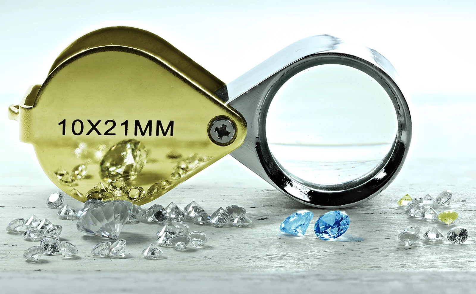 Clear, blue and yellow diamonds near magnifying glass. The Hidden Risks of Diamonds: Namdia Robbery Claims Two Lives. News