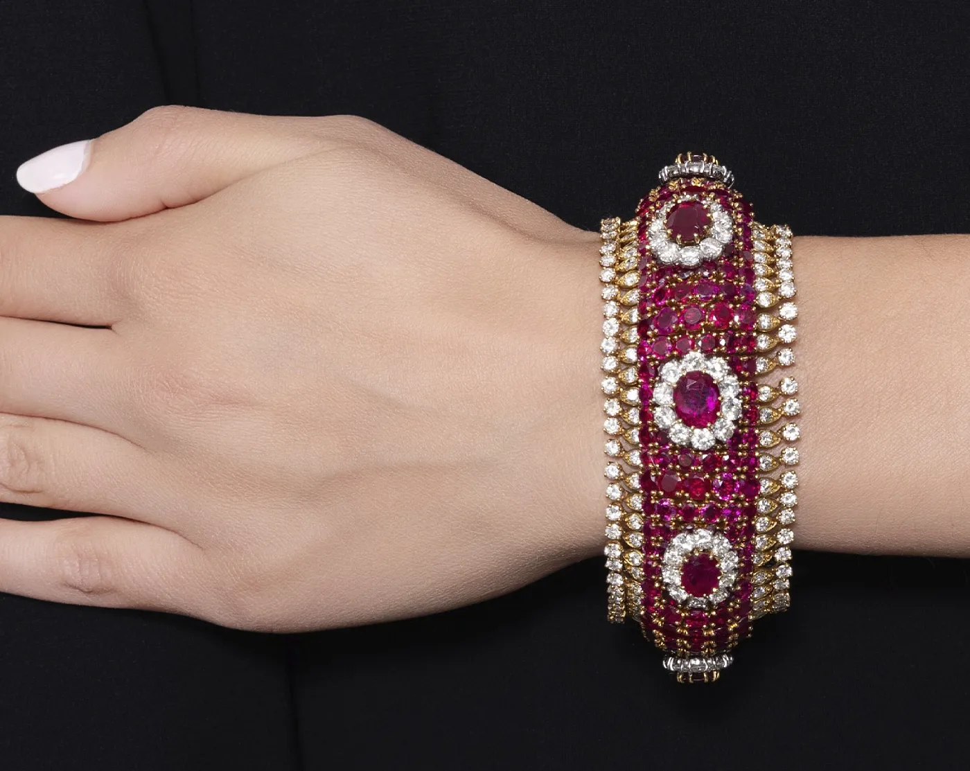 1970s Attributed to Harry Winston Ruby and Diamond bracelet on a womans hand. Luxury Auction in Saudi Arabia: Jewelry Struggles as Fine Art Dominates. News