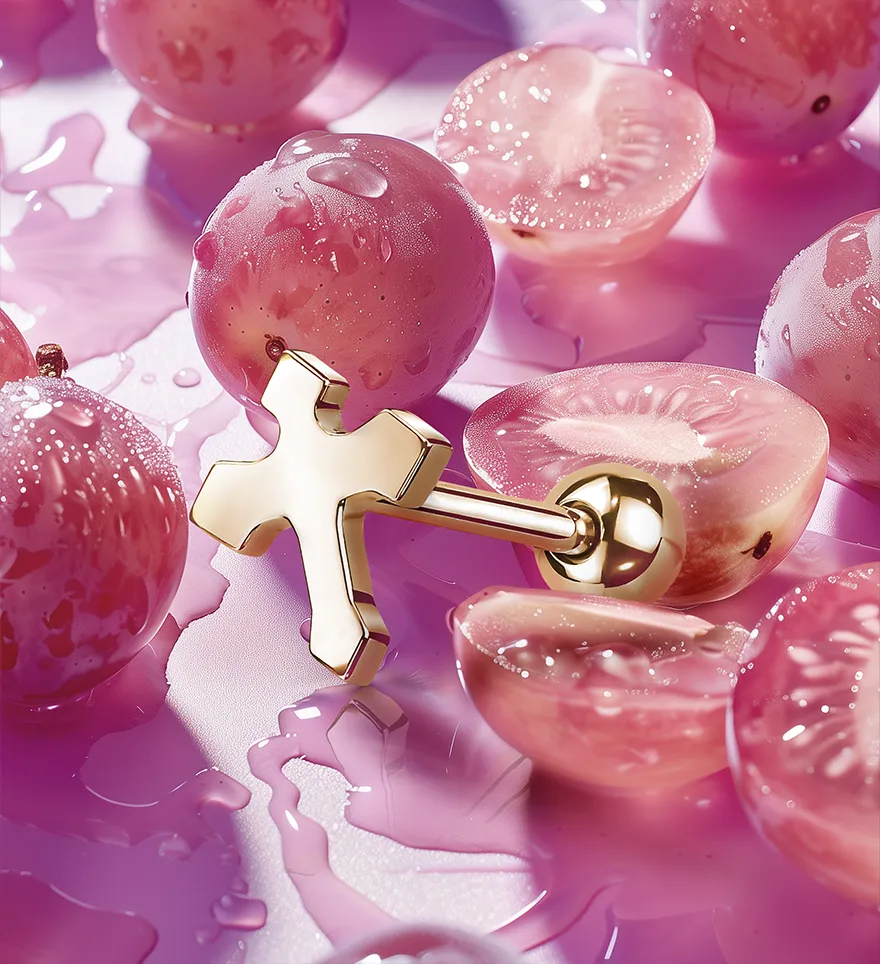 18K Yellow Gold No Gemstones Cross Design Tongue Ring. Pink purple grapes background. Custom Tongue Rings. US