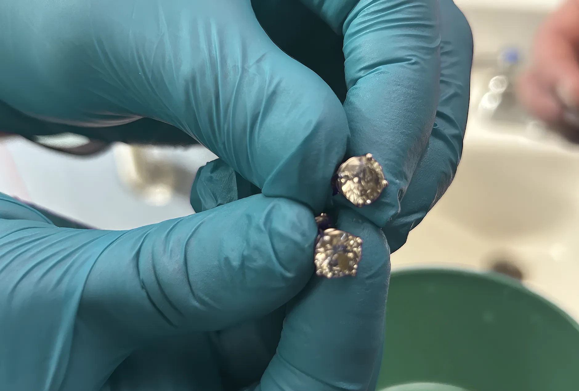 2 Stud earrings with large diamonds in the doctors hands. Florida Tiffany Heist Ends with Recovery of Swallowed Diamonds. News