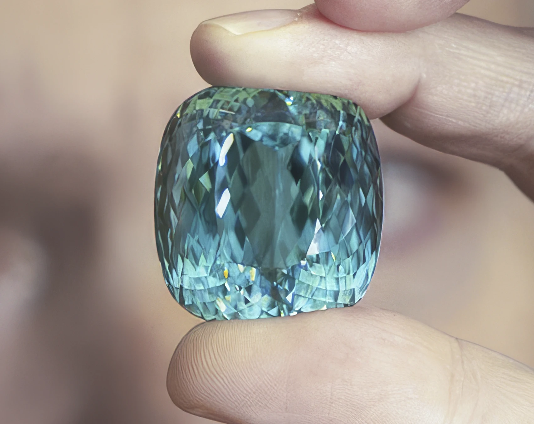 A large turquoise colored Paraiba tourmaline on close inspection. From Dust to Dazzle: A 182-Carat Gem Awakens After 12 Years. News