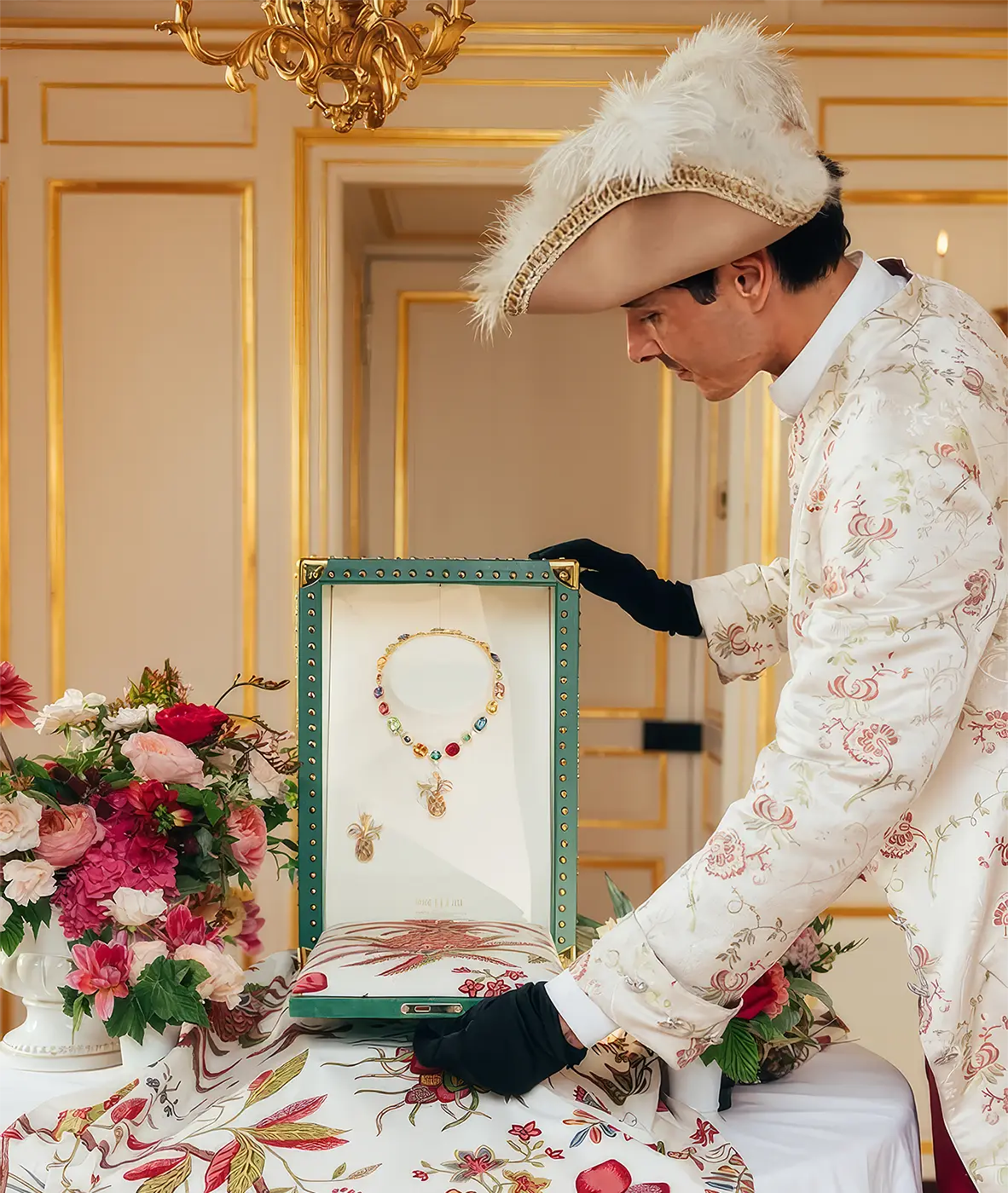 Mellerio Creates Pineapple-Themed Jewelry Set Inspired by Marie Antoinette’s Décor. News | Olertis A man in medieval costume shows off a pineapple necklace and earring. Mellerio Creates Pineapple-Themed Jewelry Set Inspired by Marie Antoinette’s Décor. News