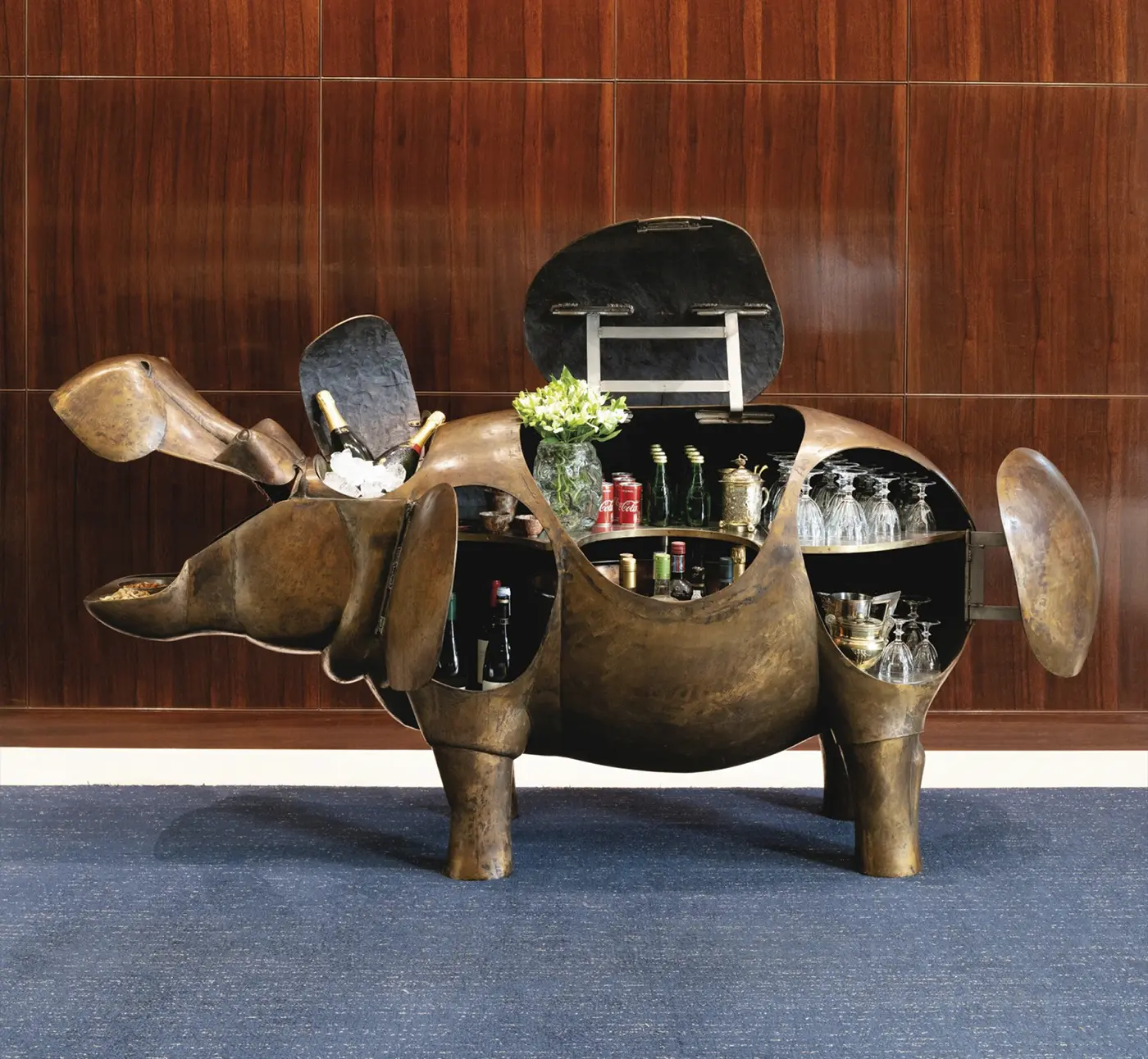 Sotheby’s Will Auction Anne Schlumberger’s Collection of Jewelry & Art. News | Olertis A 1976 bar sculpture by François-Xavier Lalanne, crafted from copper, nickel silver, stainless steel, brass, and painted wood, shaped as a hippopotamus. The bar is full and open. Side view. Sotheby’s Will Auction Anne Schlumberger’s Collection of Jewelry & Art. News