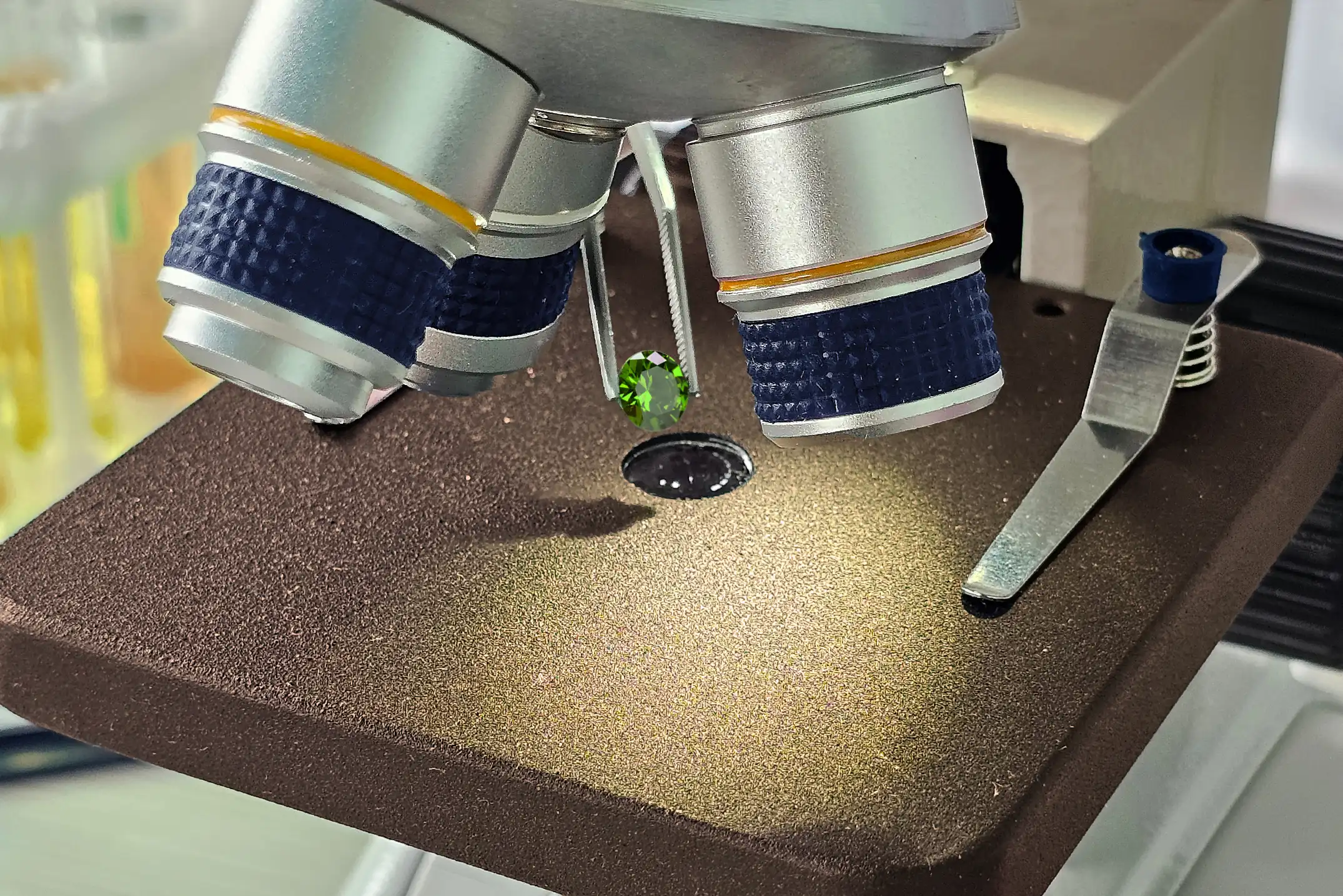 Custom Jewelry Pricing: Stones and Certification Explained. Olertis A unique peridot is examined under a microscope for certification. Custom Jewelry Pricing: Stones and Certification Explained. US
